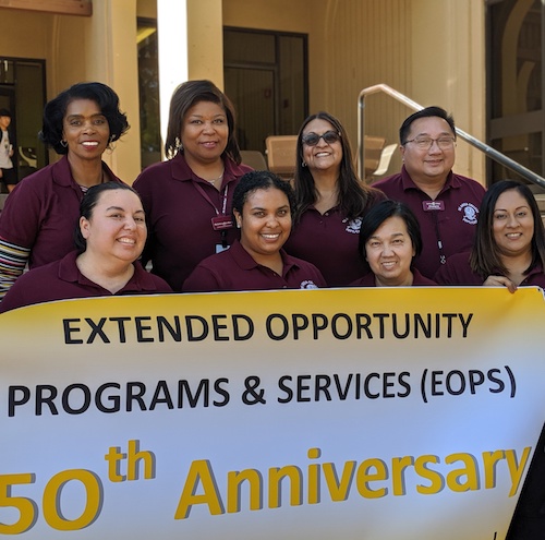 EOPS faculty and staff hold banner celebrating the program's 50th anniversary